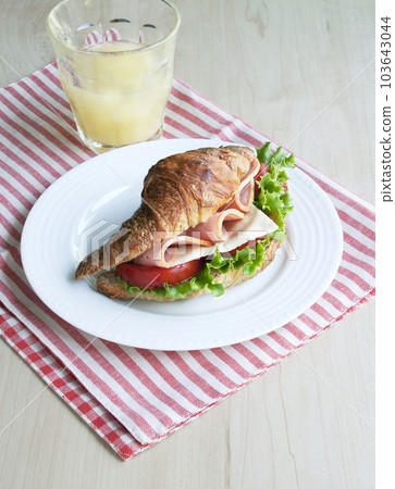 croissant sandwich and juice 103643044