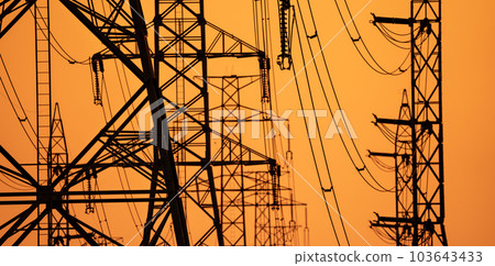High voltage electric transmission tower. High voltage power lines on electric pylon against a sunset sky. Electrical infrastructure. Energy crisis. Electric power distribution. Energy distribution. High voltage electric transmission tower. High voltage power lines on electric pylon against a sunset sky. Electrical infrastructure. Energy crisis. Electric power distribution. Energy distribution. 103643433