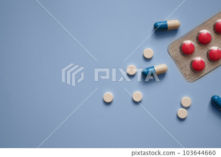 pills and capsules on a blue background, medication, medical workers day, medical care, banner for the hospital, nurses day 103644660
