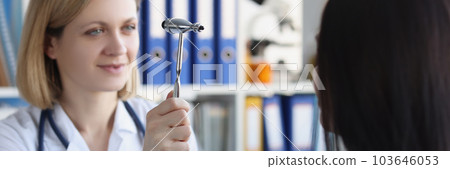 Female neurologist examines patient with hammer in private clinic Female neurologist examines patient with hammer in private clinic 103646053