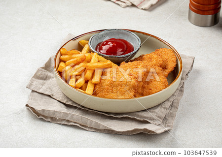 Chicken schnitzels with french fries and ketchup Chicken schnitzels with french fries and ketchup 103647539
