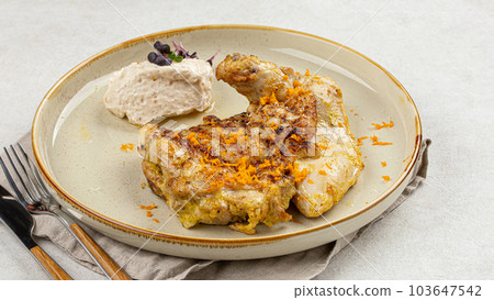 Portion of cooked chicken with nut cream Portion of cooked chicken with nut cream 103647542
