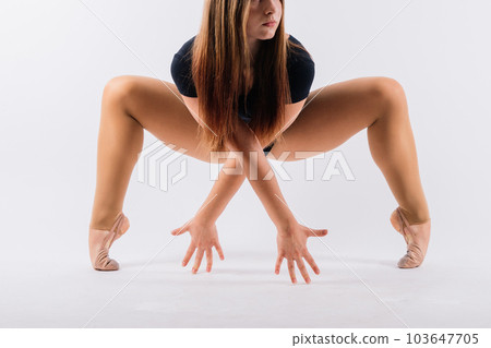 Full length teen girl smiling doing fitness exercises, isolated on white and dark background Full length teen girl smiling doing fitness exercises, isolated on white and dark background 103647705