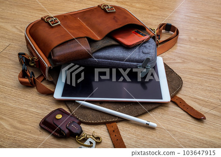 Hand made Genuine Leather Messenger Bag on the floor 103647915