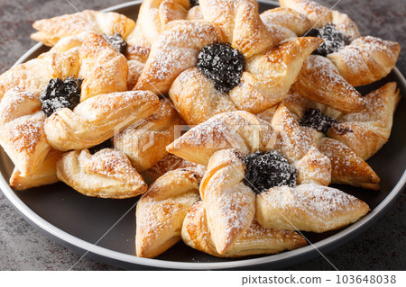 Finnish christmas time Joulutorttu puff pastries with dried plum marmalade close-up in a plate. Horizontal 103648038