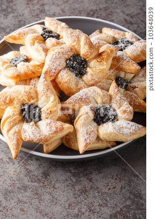 Joulutorttu Tahtitorttu Finnish Pinwheel Shaped Christmas Tarts close-up in a plate. Vertical 103648039