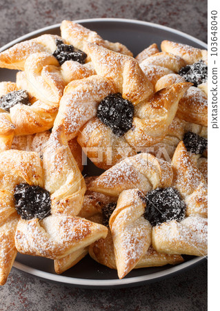 Finnish star-shaped joulutorttu christmas cake with dried marmalade close-up in a plate. Vertical 103648040