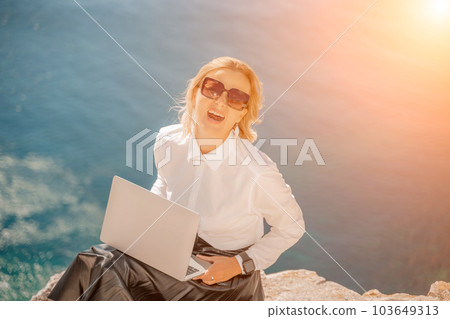 Business woman on nature in white shirt and black skirt. She wor Business woman on nature in white shirt and black skirt. She wor 103649313