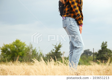 Hipster woman style. Millennial yellow and black checkered plaid shirt. Design. Fashion lifestyle. Casual clothes. Blue denim Hipster woman style. Millennial yellow and black checkered plaid shirt. Design. Fashion lifestyle. Casual clothes. Blue denim 103651213