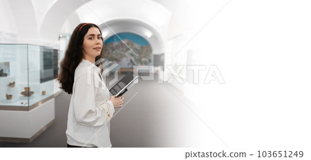 Web banner of educational excursion. Young caucasian woman holds brochure visiting museum. Light hall in background. Mock up and copy space. Concept of cultural exhibition Web banner of educational excursion. Young caucasian woman holds brochure visiting museum. Light hall in background. Mock up and copy space. Concept of cultural exhibition 103651249