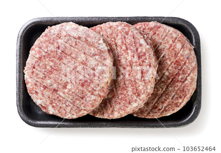 Raw burger patties in a package on a white background.Top view Raw burger patties in a package on a white background.Top view 103652464