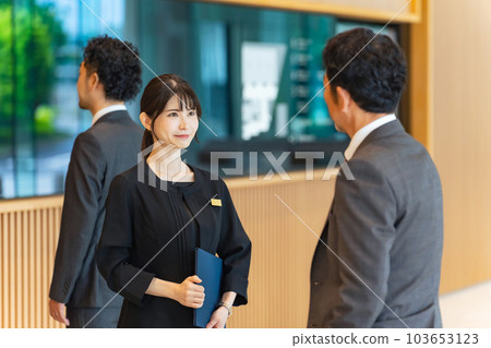 An usher woman serving tourists at the front desk 103653123