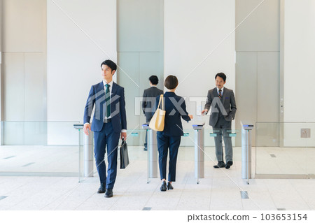 A group of business people passing through the entrance/exit gate Office security A group of business people passing through the entrance/exit gate Office security 103653154
