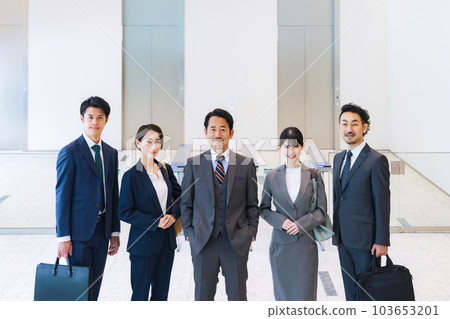 Group of smiling business people lined up in office building lobby Group of smiling business people lined up in office building lobby 103653201