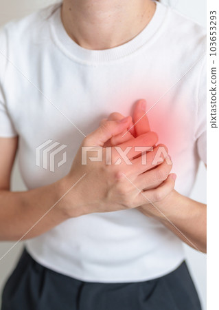 Woman hand holding chest ache. Heart disease, angina disease and symptom heart attack disease Cardiovascular, Atherosclerosis, Hypertensive, Breast Cancer awareness, world Heart day and health concept Woman hand holding chest ache. Heart disease, angina disease and symptom heart attack disease Cardiovascular, Atherosclerosis, Hypertensive, Breast Cancer awareness, world Heart day and health concept 103653293