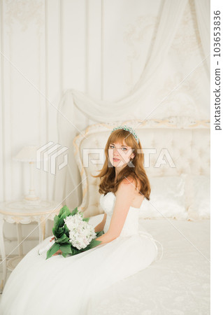 Luxury bride in white dress posing while preparing for the wedding ceremony 103653836