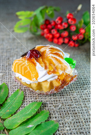Fruit cake. Dessert tartlet with cream and fruit filled with sweet caramel. Fruit cake. Dessert tartlet with cream and fruit filled with sweet caramel. 103654064