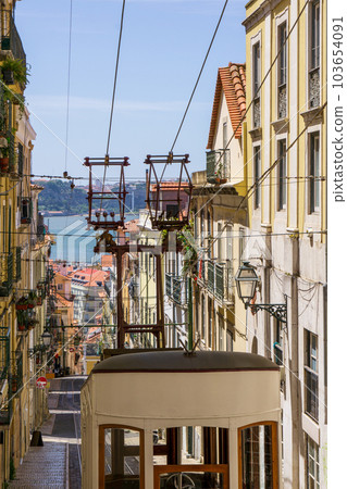 Bright sunny street in the old center of Lisbon with funicular Bright sunny street in the old center of Lisbon with funicular 103654091