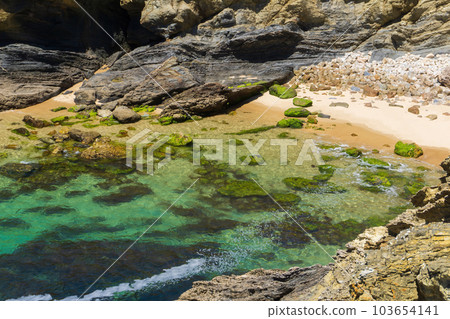 Atlantic ocean coastline with rocks, light sand and turquoise water 103654141