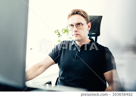 Male stock broker trading online watching charts and data analyses on multiple computer screens. Male stock broker trading online watching charts and data analyses on multiple computer screens. 103656482