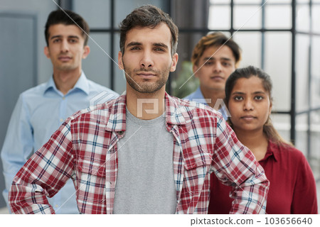 Smiling businessman with colleagues standing in row 103656640