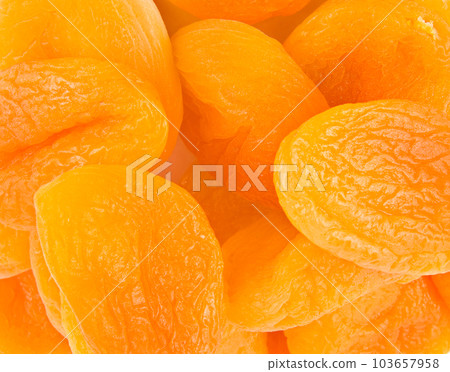 Background of appetizing golden dried apricots. 103657958