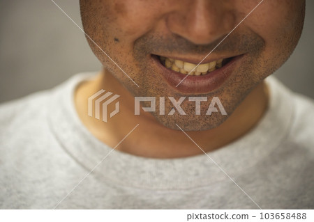 A man with a dubious smile A middle-aged man with a thick beard laughing with his teeth sticking out 103658488