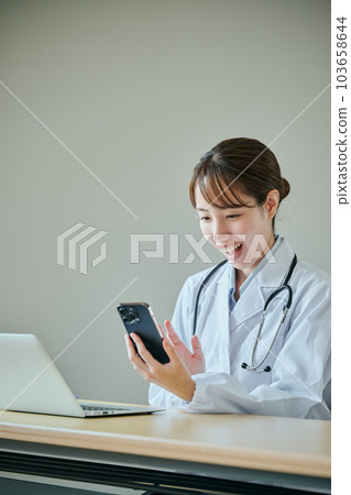 Young female doctor doing online medical treatment 103658644