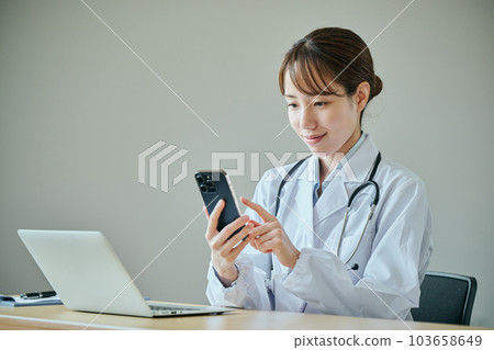 Young female doctor doing online medical treatment 103658649