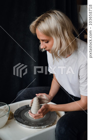 ceramist works behind a potter's wheel ceramist works behind a potter's wheel 103658718