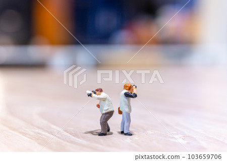 Miniature people Photography holding a camera and copy space for text 103659706