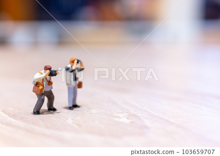 Miniature people Photography holding a camera and copy space for text 103659707