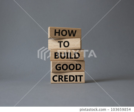 How to build good credit symbol. Concept words How to build good credit on wooden blocks. Beautiful grey background. Business and How to build good credit concept. Copy space. 103659854