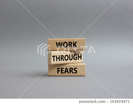 Work through fears symbol. Wooden blocks with words Work through fears. Beautiful grey background. Business and Work through fears concept. Copy space. 103659971