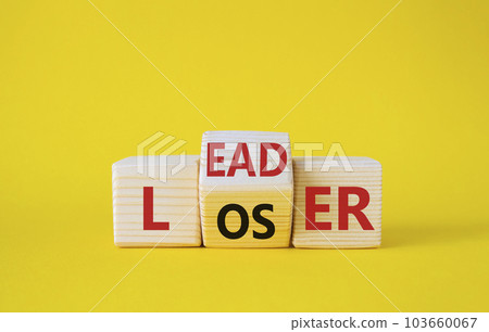 Leader vs Loser symbol. Wooden cubes with words Loser and Leader. Beautiful yellow background. Leader vs Loser and business concept. Copy space Leader vs Loser symbol. Wooden cubes with words Loser and Leader. Beautiful yellow background. Leader vs Loser and business concept. Copy space 103660067