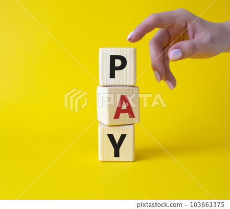 Payment symbol. Wooden cubes with words Pay. Businessman hand. Beautiful yellow background. Business and Pay concept. Copy space. 103661375