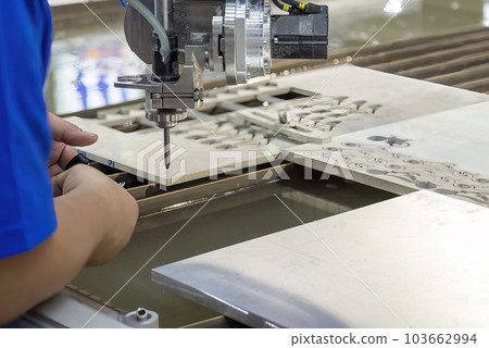Machine operator setup the multi-axis abrasive waterjet cutting machine. 103662994