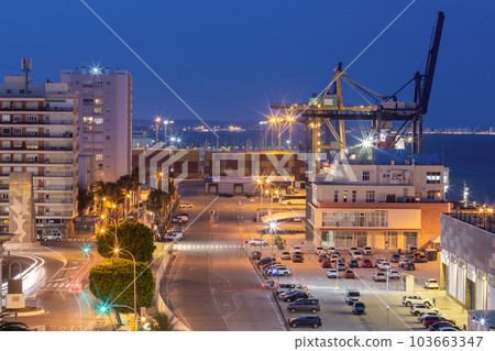 Container terminal in the port of Cadiz at sunset in night illumination. 103663347