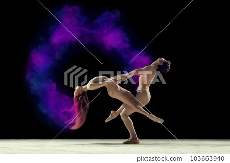 Expressive dance. Young man and woman, ballet dancers making performance with powder explosion against black studio background Expressive dance. Young man and woman, ballet dancers making performance with powder explosion against black studio background 103663940