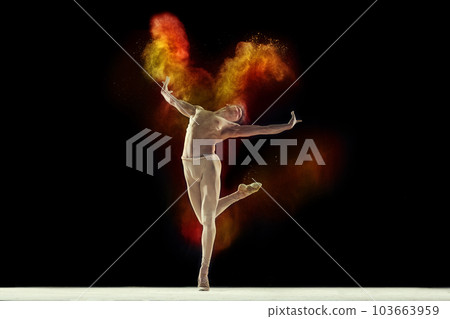 Freedom. Muscular young man, professional ballet dancer in beige bodysuit dancing with colorful powder explosion against black studio background Freedom. Muscular young man, professional ballet dancer in beige bodysuit dancing with colorful powder explosion against black studio background 103663959
