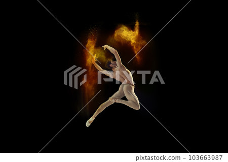 Flexible, muscular, young man, professional ballet dancer in beige bodysuit dancing with colorful powder explosion against black studio background 103663987