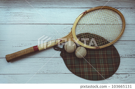A vintage tennis racket with balls on wood background. 103665131