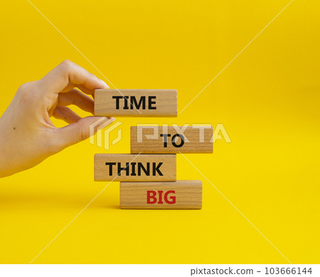 Time to think big symbol. Wooden blocks with words Time to think big. Beautiful yellow background. Businessman hand. Business and Time to think big concept. Copy space. Time to think big symbol. Wooden blocks with words Time to think big. Beautiful yellow background. Businessman hand. Business and Time to think big concept. Copy space. 103666144