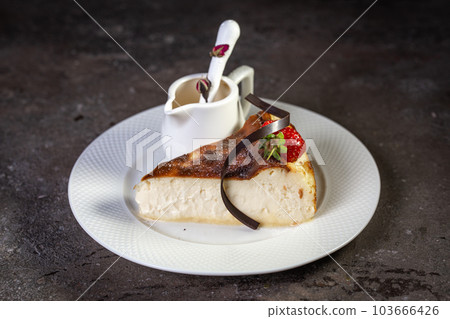 a delicate curd slice of cheesecake with strawberries and condensed milk 103666426
