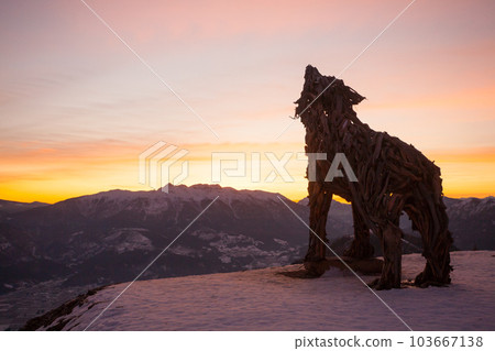 Wooden sculpture of a wolf. Italian landmark at dawn 103667138
