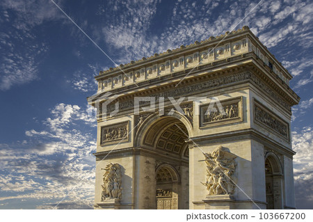 Arc de Triomphe (against the background of sky with clouds), Paris, France. The walls of the arch are engraved with the names of 128 battles and names of 660 French military leaders (in French) Arc de Triomphe (against the background of sky with clouds), Paris, France. The walls of the arch are engraved with the names of 128 battles and names of 660 French military leaders (in French) 103667200