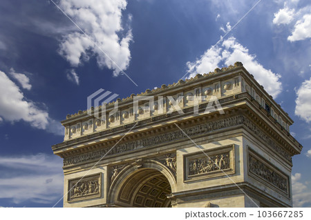 Arc de Triomphe (against the background of sky with clouds), Paris, France. The walls of the arch are engraved with the names of 128 battles and names of 660 French military leaders (in French) 103667285