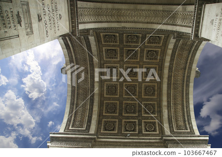 Arc de Triomphe (against the background of sky with clouds), Paris, France. The walls of the arch are engraved with the names of 128 battles and names of 660 French military leaders (in French) 103667467