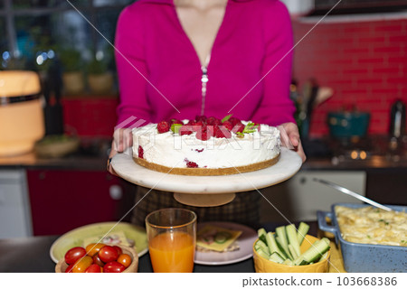 woman serving strawberry cake woman serving strawberry cake 103668386
