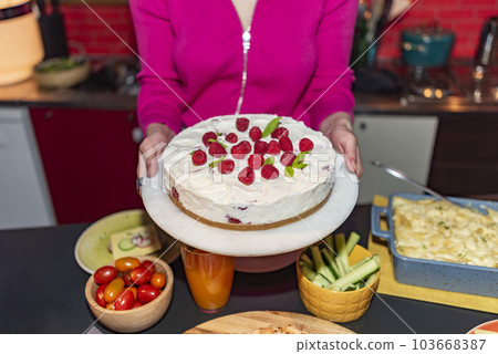 woman serving strawberry cake 103668387
